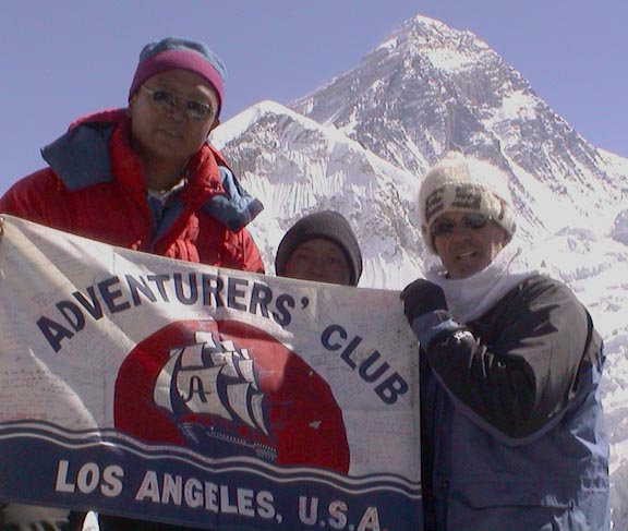 Photo of Bob Gannon in front of Mt. Everest with Adventurers' Club Flag